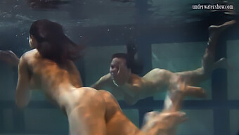 Russian Swimsuit Models Playfully Touch Their Breasts Underwater In A Pool